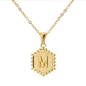 Detailed close-up of 18K gold stainless steel hexagonal pendant with letter M detail
