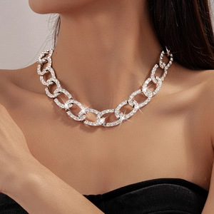 Close-up of sparkling rhinestone pavé silver chain necklace worn by a fashion model