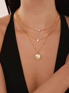 Three-layer gold necklace with pearl, star pendant and embossed shell wave medallion