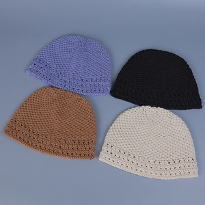 Detailed top view of handmade crochet hats in lilac, black, brown and beige colors