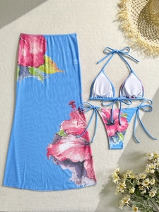 Detailed flat lay of a 3-piece floral bikini set with matching blue mesh beach sarong