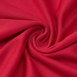 Close-up of red breathable knitted fabric showing fine texture and mesh detail