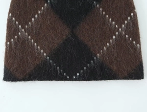 Close-up of brown and black argyle pattern on fuzzy mohair knit sweater fabric