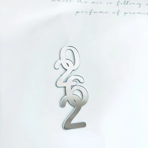Detailed view of silver mirror acrylic 2026 number toppers for Christmas cake decor
