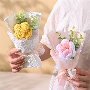Handheld display of handmade knitted sunflower bouquets in yellow and pink paper wrap