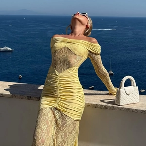 Detailed view of yellow lace off-shoulder dress with elegant ruched texture at the seaside