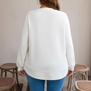 Rear view of white waffle knit sweatshirt showing relaxed fit and curved hemline