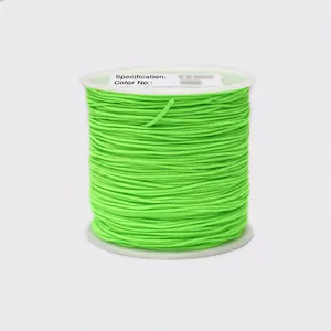 Close-up of 0.8mm bright green cord on a white spool for DIY jewelry and knotting