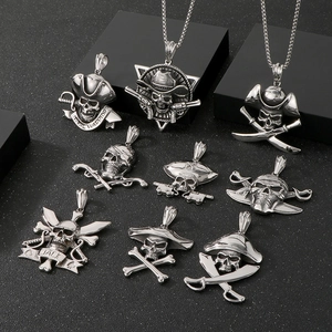 Macro detail of stainless steel pirate skull pendants with Naval Warrior engravings