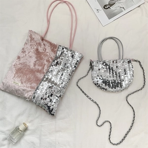 Detail of pink velvet and silver sequin tote set with small chain bag on textured background