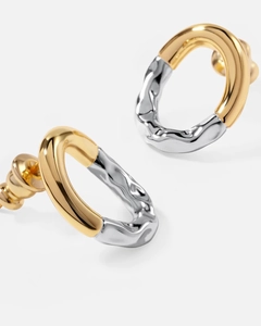 Macro shot of 18K gold and silver two-tone round earrings with balloon pleated texture