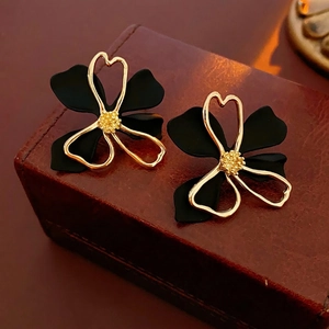 Double-layer hollow flower earrings with matte black petals and gold-rimmed edges
