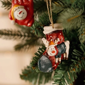Christmas snowman and reindeer stocking ornaments hanging on a festive Xmas tree