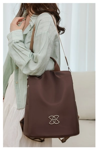 Detail of adjustable straps on dark brown anti-theft waterproof nylon travel backpack