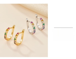 Macro shot of 925 silver hoop earrings with rainbow cubic zirconia pavé setting