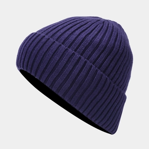 Detailed close-up showing the deep purple ribbed knit texture of the warm winter beanie
