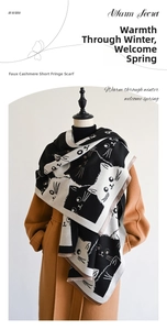 Detail of soft faux cashmere scarf featuring cute black and white cat patterns and fringe