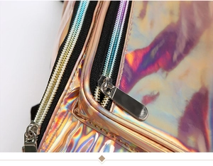 Macro shot of colorful holographic PVC fabric with polished silver zipper and black nylon track