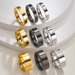 Polished stainless steel ring set in gold, black and silver finishes on display