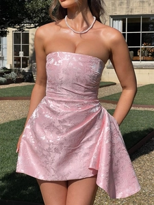 Close-up of pink jacquard fabric texture on a slim strapless bodycon mini evening dress