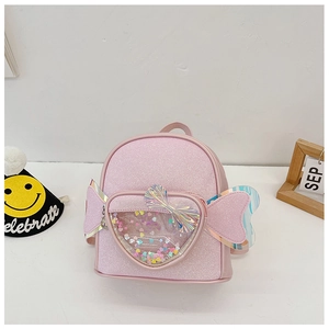 Detailed view of pink sequin mini backpack with decorative wings and heart pocket