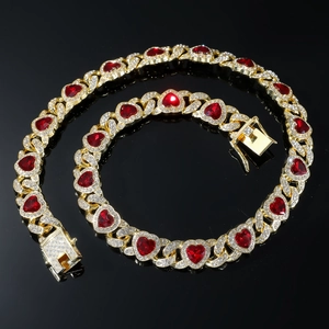 Macro shot of gold-plated heart-shaped links with red gemstones and sparkling rhinestones