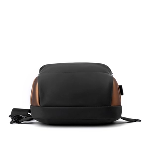Detailed bottom view of waterproof black chest bag with brown synthetic leather accents