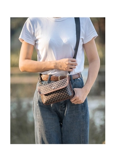 Close-up of vintage brown patterned mini crossbody bag worn as a stylish waist pack