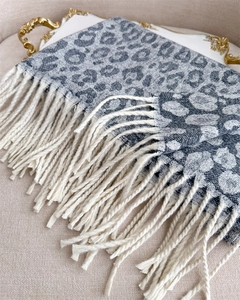 Close-up of grey and white leopard jacquard scarf featuring delicate fringe details