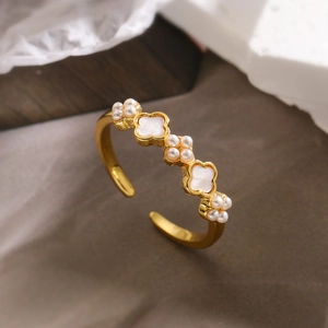 Detailed macro view of 18K gold plated ring with white shell petals and pearl clusters