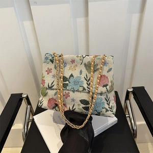 Floral jacquard chain shoulder bag with gold woven strap and vibrant printed pattern