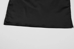 Close-up of the smooth black polyester fabric showing precise single-stitch hem detail