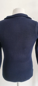 Close-up of navy blue knitted fabric texture and stand collar detail on casual cardigan