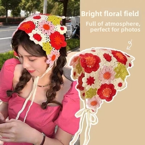 Detail showing colorful hand-knitted floral crochet bandana with bohemian triangle pattern
