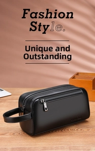 Detail of black pebbled leather men's clutch featuring dual zippers and a sturdy side handle