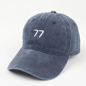 Detailed side view of washed navy baseball cap featuring white 77 embroidery