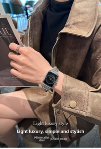 Detail of silver chain bracelet watch with square black dial worn on a model's wrist