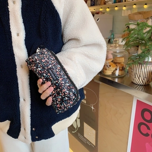 Handheld vintage floral corduroy pencil case in black with multi-color flower pattern