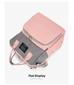 Detail view of pink and grey contrast Oxford fabric diaper bag with functional zip pockets