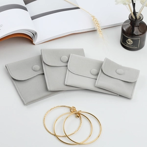 Thick velvet jewelry pouches with snap buttons in four sizes for accessory storage