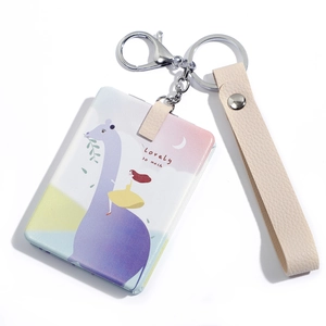 Detail of cute giraffe cartoon mirror keychain with beige leather strap and metal clasp