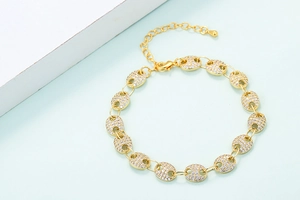 Close-up of gold-plated pig nose link bracelet with micro-pave white zircon stones