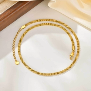 Detail of golden stainless steel mesh chain with adjustable lobster clasp and extender