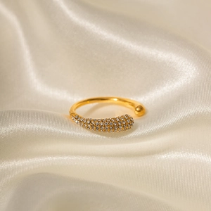 Detailed view of 18k gold plated stainless steel ring with rhinestones on beige silk