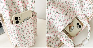 Detail of floral canvas backpack side pocket showing smartphone storage capacity