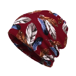 Detail of burgundy cotton beanie with multi-color feather print for winter cycling