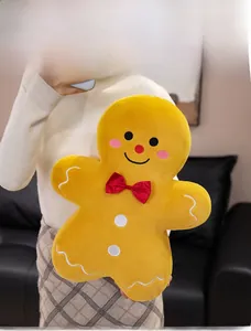 Detailed plush gingerbread man pillow with red bow tie and white icing embroidery