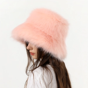 Side view of a plush pink faux fur bucket hat with thick warm texture for winter