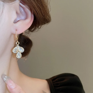 Elegant gold drop earrings featuring cat-eye stone petals and sparkling rhinestone accents