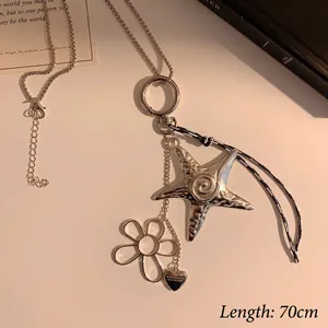 Detail of vintage silver starfish and flower pendants on a 70cm chain necklace